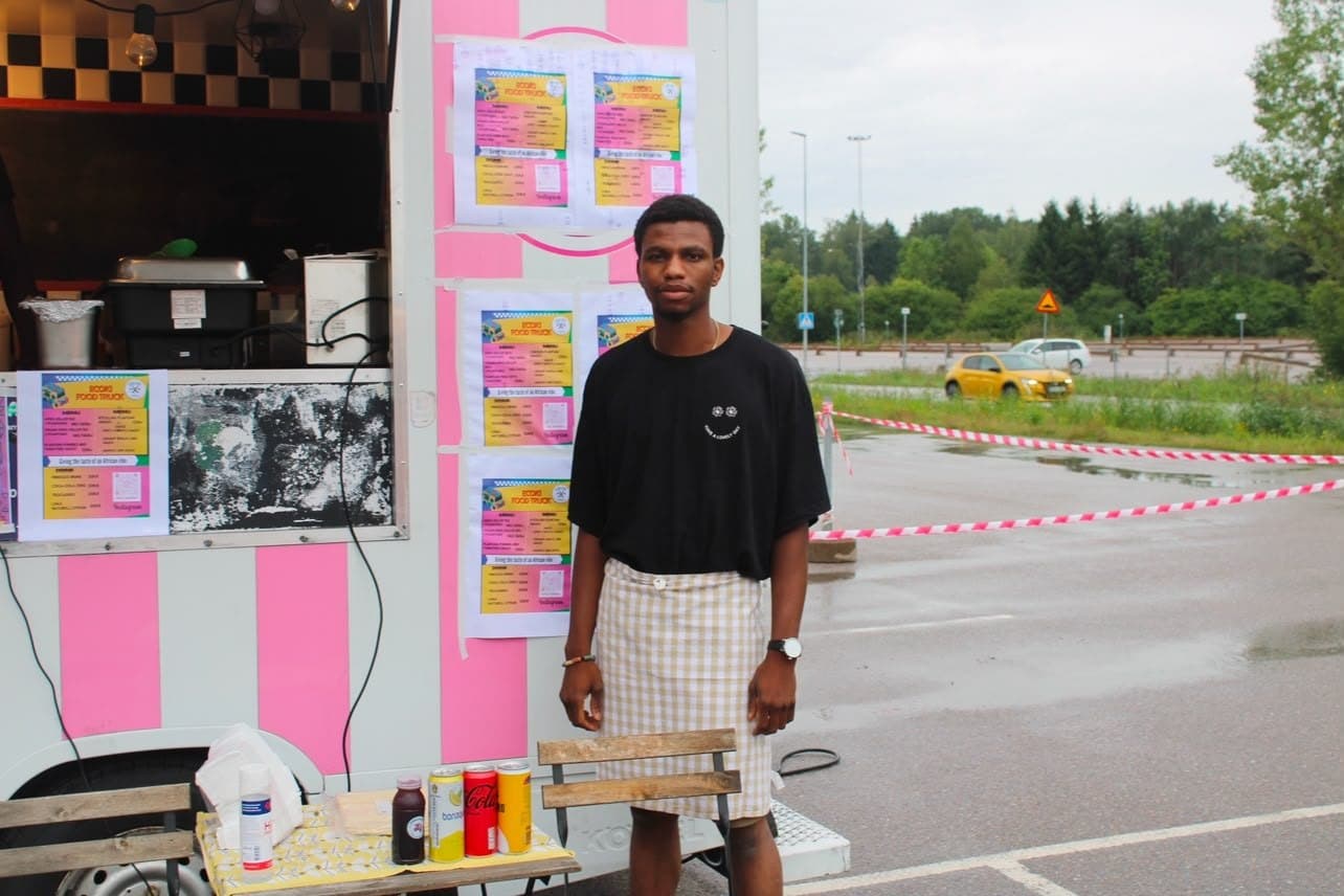 One of the Igbokwe siblings in a gingham apron