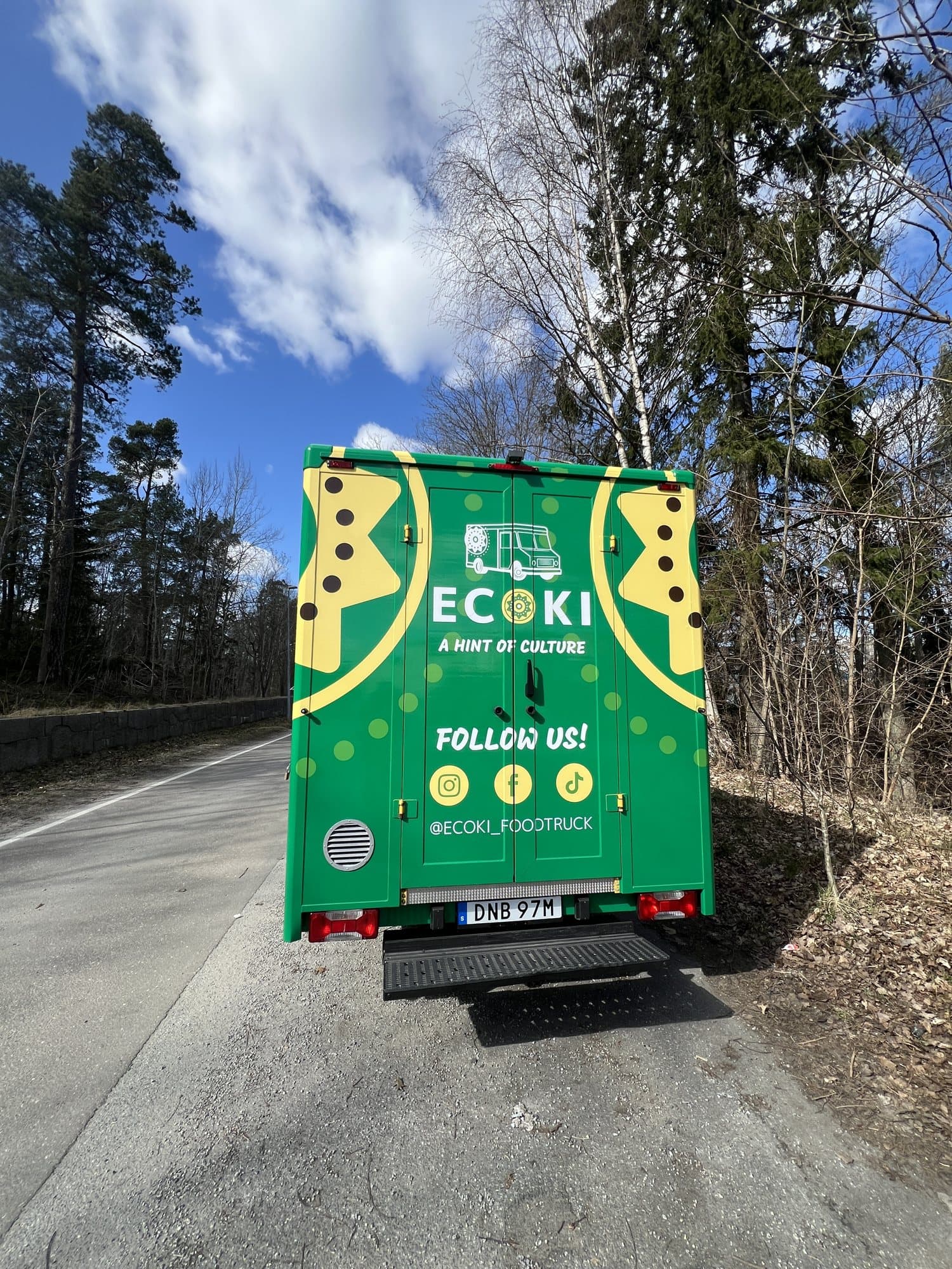 The back of the Ecoki truck with “Follow us!” and social media icons